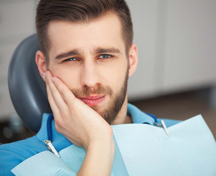 Pained man visiting Gilbert emergency dentist for tooth pain