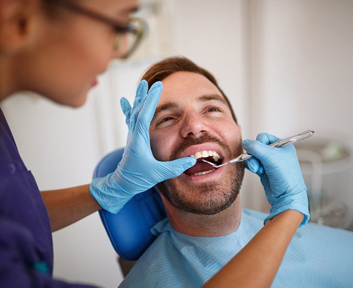 Patient receiving a preventive dentistry exam