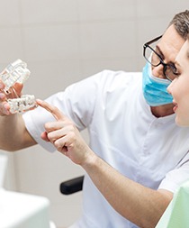 Dentist explaining how dental implants work in Gilbert to patient