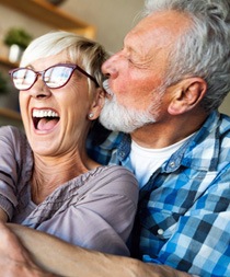 older couple smiling and hugging 