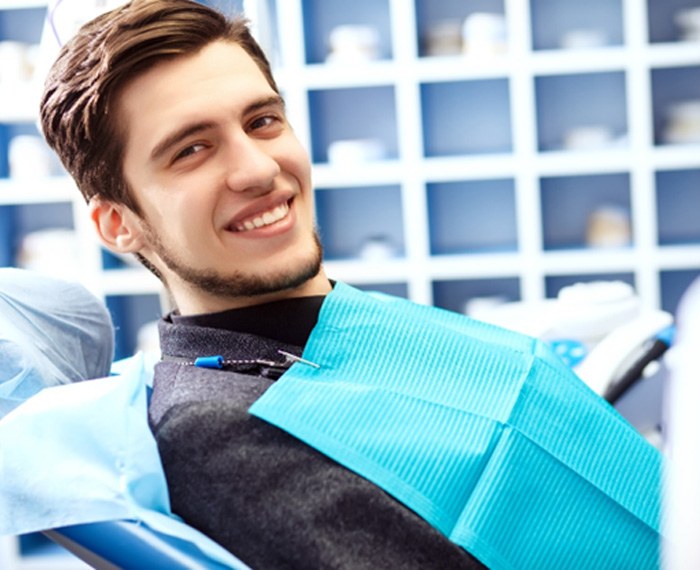 Man sitting in dental chair and smiling
