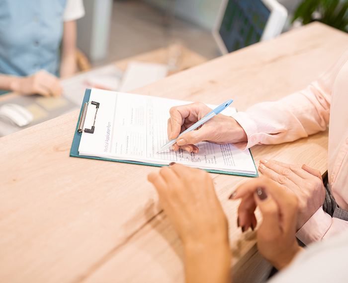 Patient completing dental insurance forms