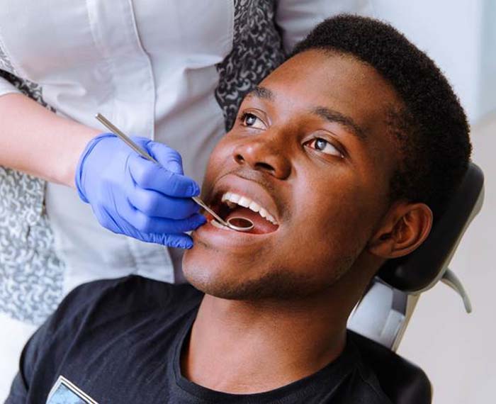 Man visiting his dentist to prevent dental emergencies in Gilbert