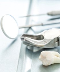 Tooth and dental instruments on table after tooth extraction in Gilbert, AZ