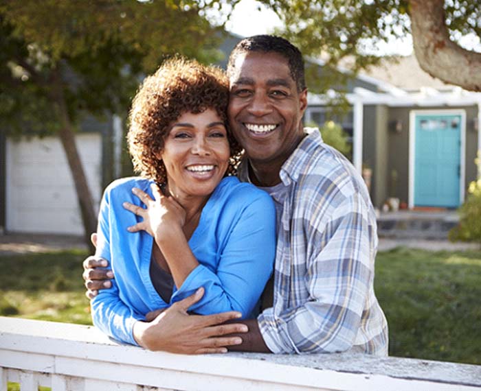 Alt image tag: happy couple smiling because of the benefits of dental implants in Gilbert