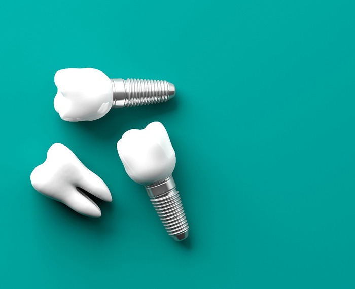 Dental implants on turquoise background