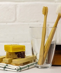 Toothbrushes next to homemade soap
