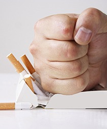 Man crushing cigarettes