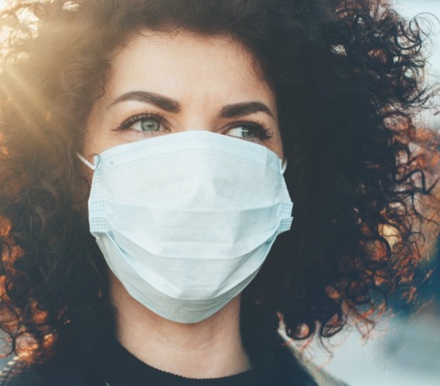 Woman wearing protective face mask outdoors