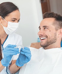 dentist explaining the cost of Invisalign in Gilbert to a patient 