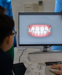 A dentist showing a patient their estimated results with Invisalign Outcome Simulator Pro with iTero Element Plus Series