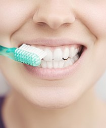 Young woman brushing teeth 