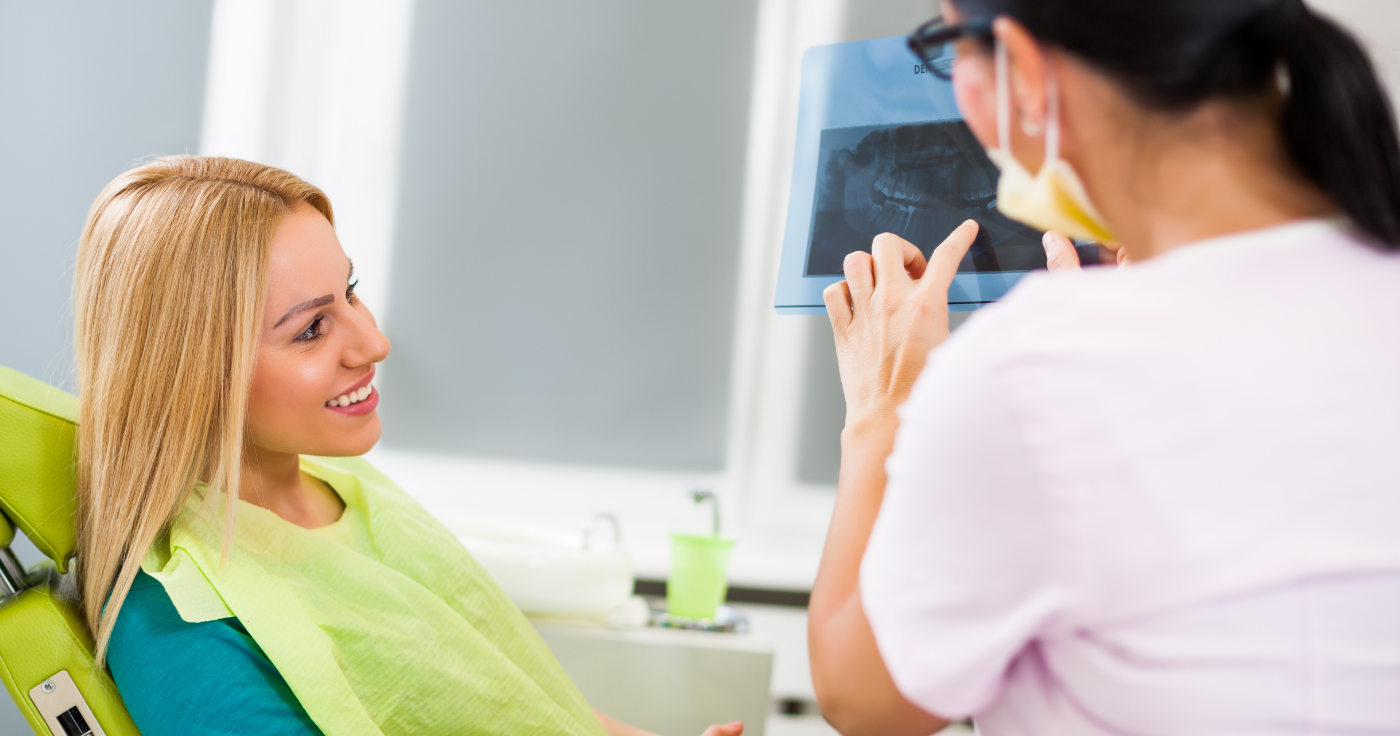 Dentist and patient looking at digital x-rays