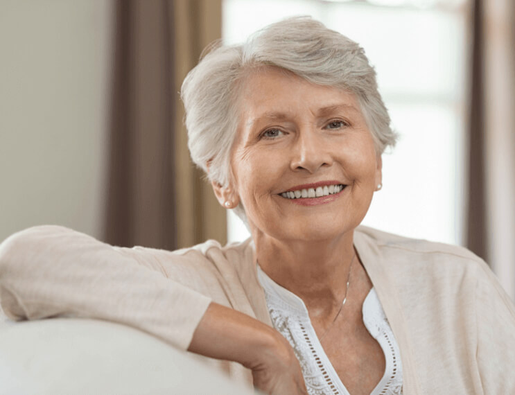 Olde woman sharing smile after replacing missing teeth