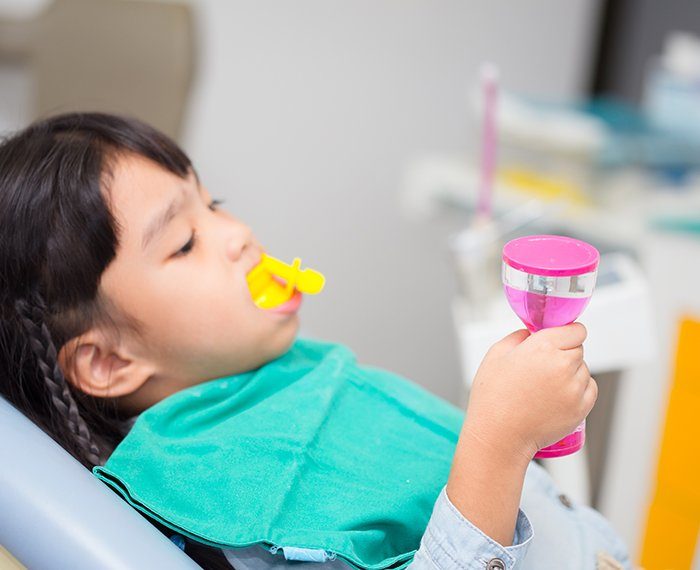 Child receiving a fluoride treatment