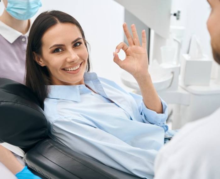 a patient smiling and giving the okay sign
