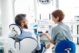 dentist going over patient X-ray