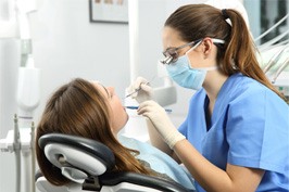 dentist working on patient’s mouth 