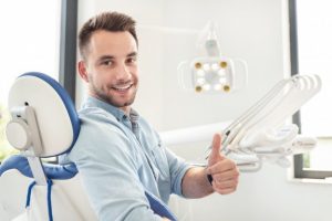 Man giving a thumb’s up during his dental visit.