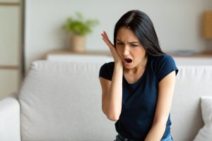 Woman in pain from a toothache.