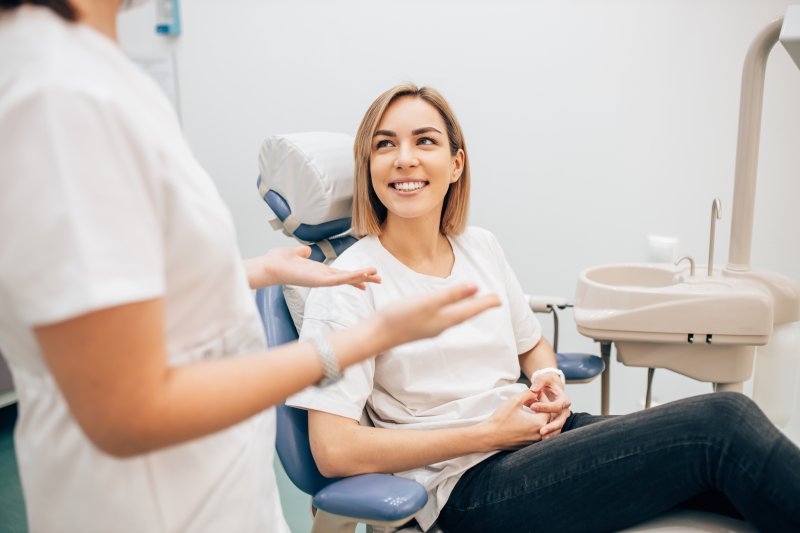 A young woman talking to her dentist