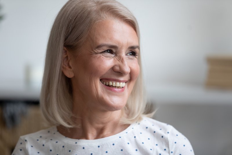 woman smiling after getting dentures