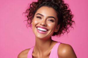 Woman in pink shirt smiling.